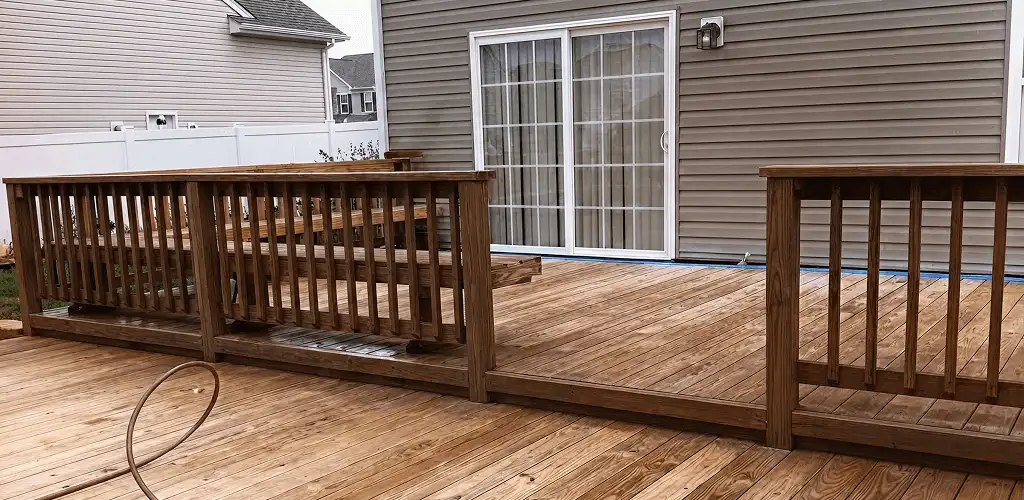 Deck sealing service protecting a backyard wood deck and railings in Pueblo, CO