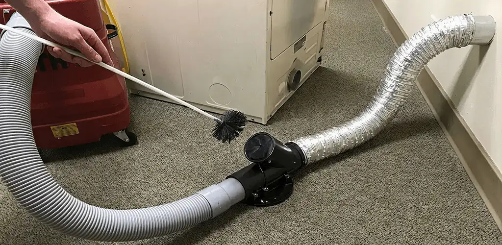 Dryer vent cleaning service removing lint from a dryer duct connection in Pueblo, CO