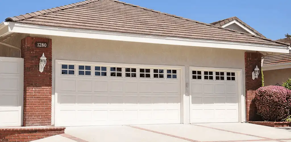 Residential garage door repair service for a double garage door in Pueblo, CO