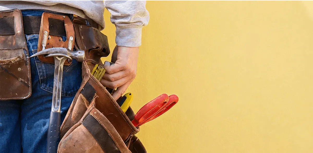 Handyman with tool belt ready for home repairs and maintenance in Pueblo, CO