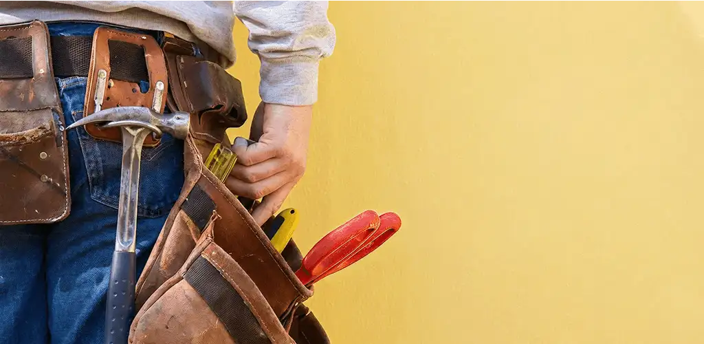 Handyman with tool belt ready for home repairs and maintenance in Pueblo, CO