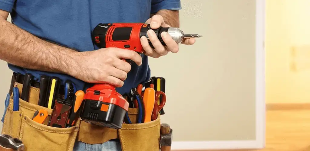 Handyman holding a power drill for home repairs and installations in Pueblo, CO