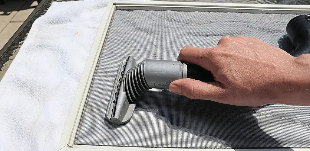 Window screen repair cleaning and fixing a damaged screen mesh in Pueblo, CO