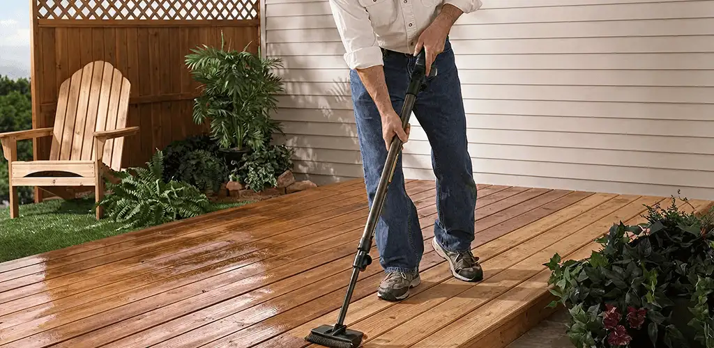 Deck staining service applying stain to a backyard wood deck in Pueblo, CO